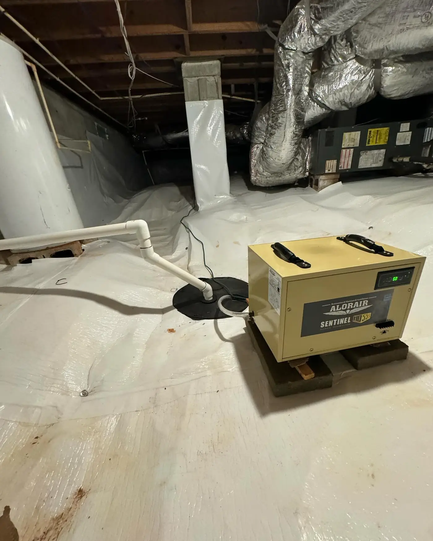 Dehumidifier and sump pump in an encapsulated crawl space