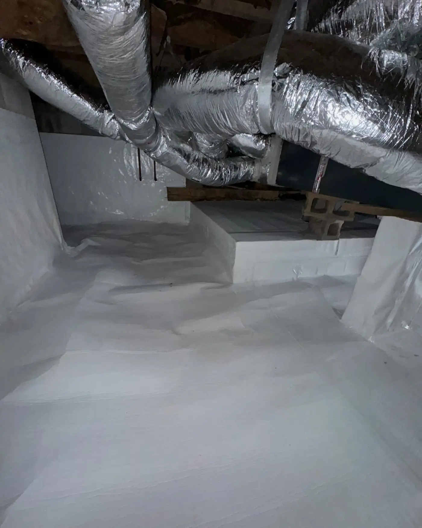 Sealed crawl space with wrapped piers