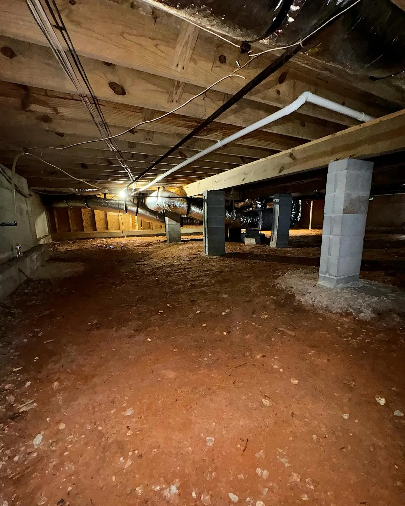 Dallas, GA crawl space before encapsulation: bare red clay floor