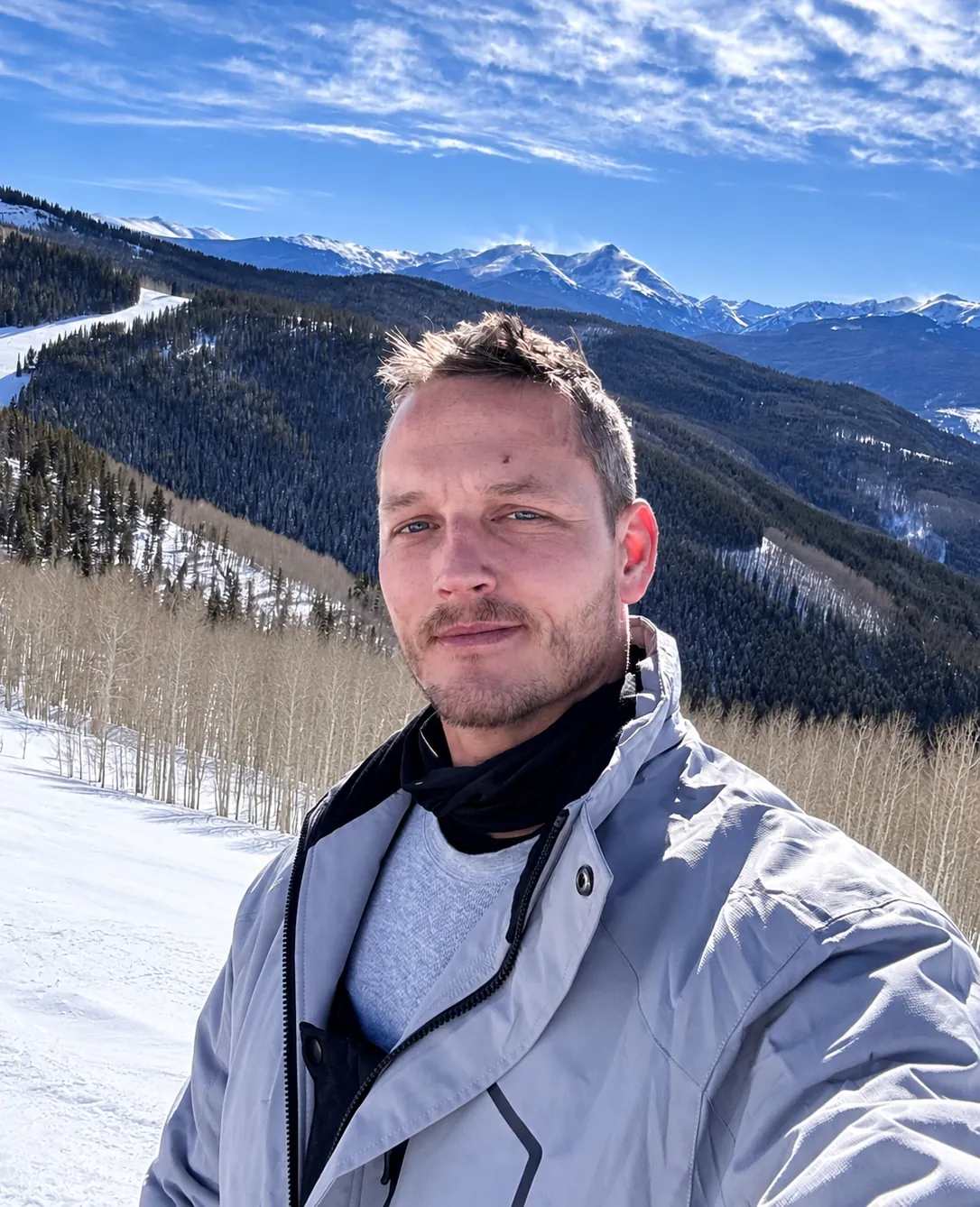 Jacob Powers, owner of PPS Waterproofing, in a winter jacket in front of snowy mountains